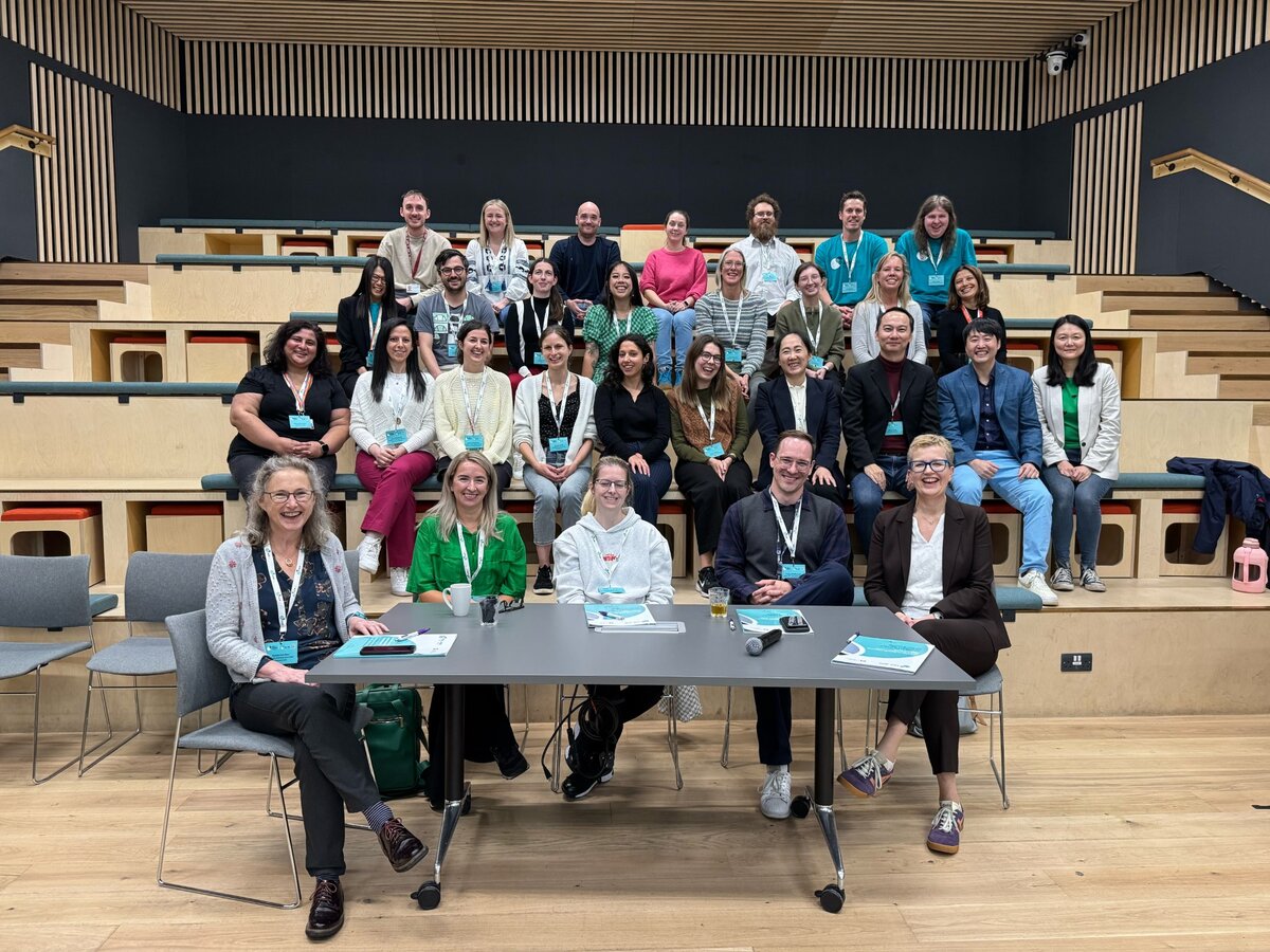 Datathon participants and judging panel sitting in a workshop room together