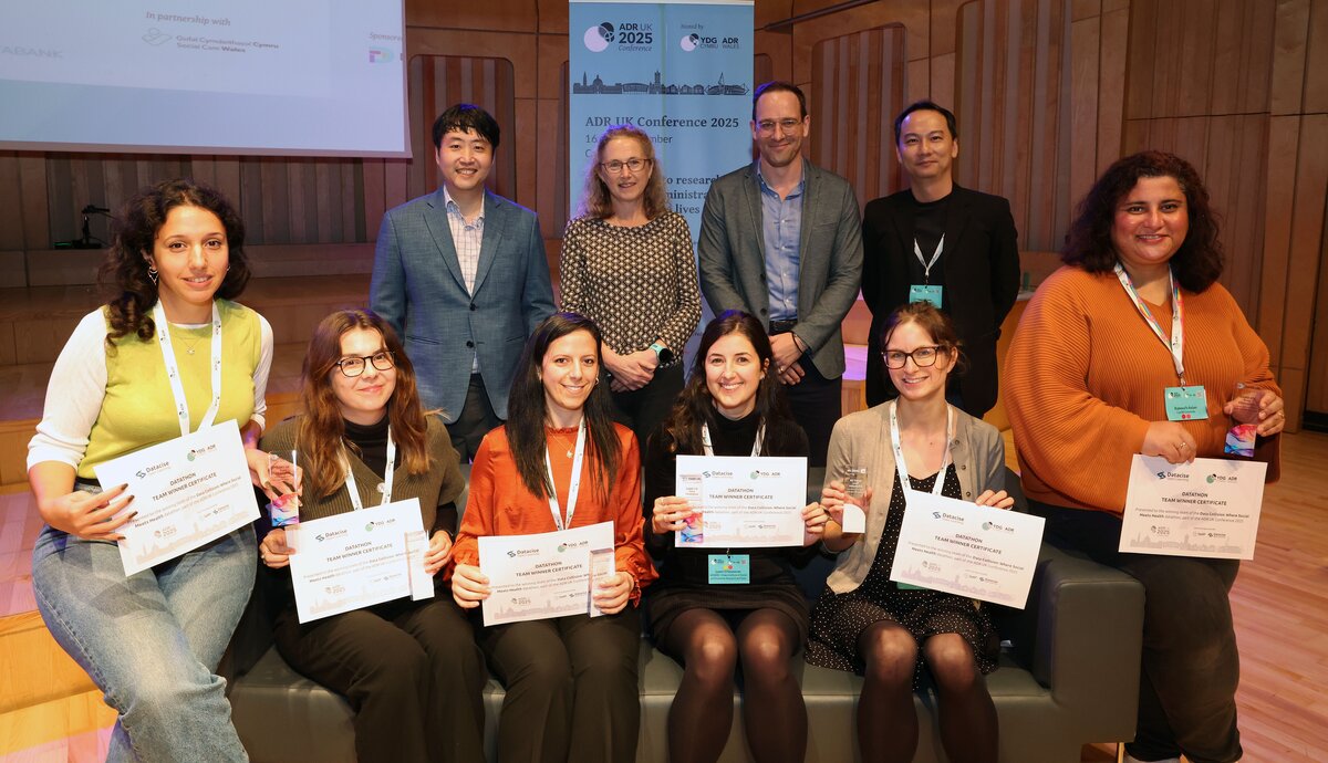 Winners of the datathon with their certificates smiling