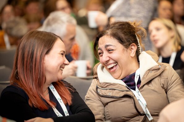 Two delegates laughing together